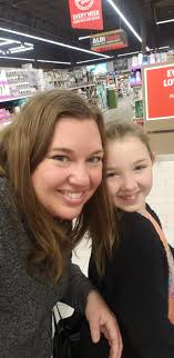 Man holds acorn candle and wears Chiefs shirt for humorous photo