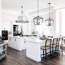 An equally stylish waterfall kitchen island is finished with black laminated wood with dramatic graining pattern, rendering a stark contrast to the neutral color scheme of the space. The Tomkat Studio On Instagram This Is The Dream Kitchen At Tomkatvictoria Our Latest And Greatest Renovat Home Kitchens Home Decor Kitchen Kitchen Remodel
