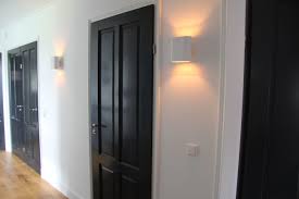 zwarte deuren in de gang met witte kozijnen en prachtige duell lamp wall white met champagne kleur van binnen zwarte deuren binnendeuren deuren interieur