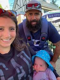 Surrogate baby and parents return home to Sydney from Canada