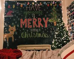 A neutral shabby chic christmas bedroom with evergreen wreaths, garlands, knit blankets and mini christmas trees a red and white bedding set, a christmas tree with lots of lights, pompom garlands and gift boxes right on the bed Vsco Ashley Mcd Christmas Feeling Christmas Decorations Bedroom Chic Christmas