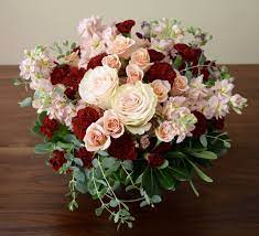 Maybe you would like to learn more about one of these? Wedding Table Flower Centerpiece With An Accent On Burgundy And Peach Colors Roses Spra Peach Wedding Centerpieces Carnation Centerpieces Flower Centerpieces