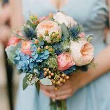 Long blue bridesmaid dresses with complementary fall bouquets. 12 Pink Roses And Blue Thistles Ideas Flowers Wedding Bouquet