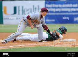 Miami Hurricanes 2B Frankie Ratcliff (19) avoids tag from 1B Ryan Durrence  (35). The 14th ranked Miami Hurricanes defeated the Bethune- Cookman  Wildcats 5-2 at Alex Rodriguez Park in Coral Gables, Florida. (