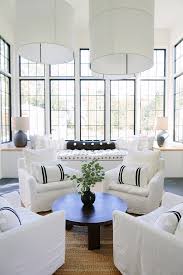 On the other side of the room, a sofa and chairs form a conversational cluster around the fireplace. Neutral Home Interior Ideas Home Bunch Interior Design Ideas