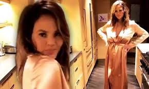 Chrissy teigen looks glamorous with baby luna in nyc. Chrissy Teigen Shows Off Her Modeling Skills In Rose Gold Robe While In Her Kitchen Daily Mail Online