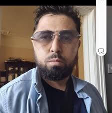 This is Omari Grey with his wife and nine children. Omari was in a vicious  head