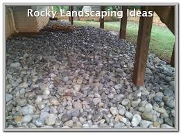 Put a rock border around your garden and make it pop! How To Have A Beautiful Landscaped Yard Landscaping Lovers Landscaping Around Deck River Rock Landscaping Deck Landscaping