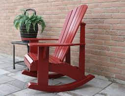 a red adirondack rocking chair on a porch next to a plant rocking chair plans adirondack rocking chair adirondack chair plans