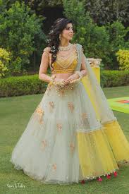 10 Trending Mehndi Outfits For Brides Online With Images Buy Lehenga Choli Online Designer Bridal Lehenga Indian Designer Outfits Lehenga Designs
