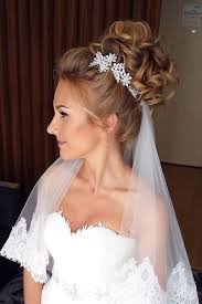 Top off a high coiled bun with its smooth locks with a gorgeous lace veil. 42 Dreamy Wedding Hairstyles With Veil Wedding Forward Bridal Hair Veil Veil Hairstyles Wedding Hairstyles Updo