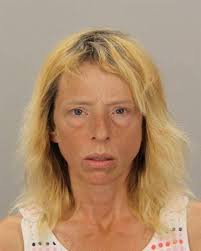 Woman arrested after threatening people with ax