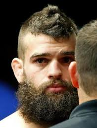 Ben Wall (top) fights Justin Salas (red gloves) during a preliminary  lightweight bout at US Bank Arena. 65107464 Editorial Image