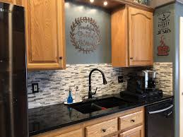 Stainless steel appliances and subway tile boast the black kitchen cabinetry. Pin On Home Remodel