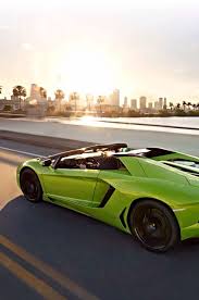 A Green Lamborghini On The Road To The City Autos