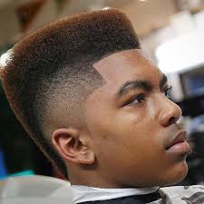 Although modern mohawks are often more on the faux hawk side because they still feature hair on the sides, these flashy men's hairstyles always make a statement. Black Men S Mohawk Hairstyles Men S Hairstyles Haircuts 2021