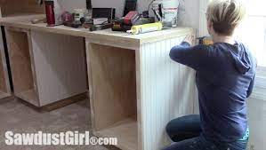 White kitchen cabinets with beadboard doors. Add Beadboard Paneling To Cabinet Sides Sawdust Girl
