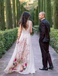 A White Sleeveless Wedding Gown With A Net Back And Bright Florals Embroidered On The Back Wedding Dresses Unique Bridal Gowns Sleeveless Wedding Gown