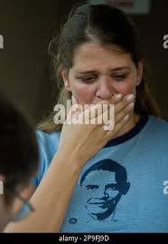 Penelope Van Tuyl of San Francisco, sheds tears after placing flowers  outside the Honolulu residence of Madelyn Payne Dunham, grandmother of  Democratic presidential candidate Barack Obama, after the announcement of  her death