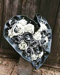A skull accent is placed in the center of every rose making it a great addition to any gothic/halloween wedding. Misfit Wedding Gothic Skulls Bridal Bouquet For A Halloween