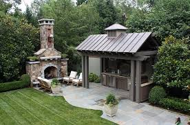 Detailed wood accents, like the curved frames and above the grills and cabinets doors, finish the rich look. Designing The Perfect Outdoor Kitchen