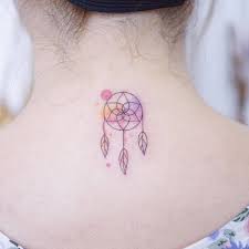By looking imperfect, this watercolor dreamcatcher tattoo is head and shoulders above its counterparts. Watercolor Dreamcatcher Tattoo On The Upper Back