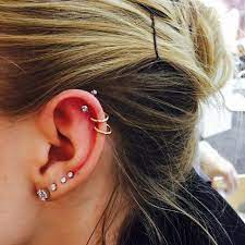 Beautiful Ear Adorned With Four Lobe And Three Helix Piercings The Top One Freshly Pierced With The Ge Cool Ear Piercings Cute Ear Piercings Earings Piercings