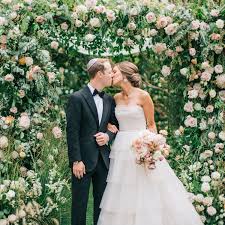 Happy child giving big bouquet of spring flowers to woman for mother`s day. 20 Stunning Wedding Flower Wall Ideas