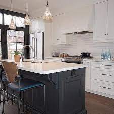 The matte black kitchen island is an elegant addition, the bright red fittings add a splash of color. Vintage Two Tone Kitchen Island Lights Design Ideas