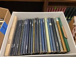Stack of traditional high school yearbooks