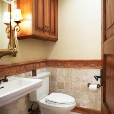 Honed carrera marble on light gray mini washstand with brass pulls in a transitional bathroom. Photos Hgtv