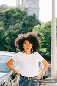 One of the main reasons your locks can look less defined is because the surface of the hair has been disturbed. Pretty Ethnic Woman In White T Shirt And With Black Curly Hair Looking At Camera On Street Chic Stylish Stock Photo 295759952