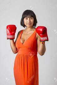 Young Sexy Philipino Woman, Wearing A Low Cut Orange Dress, With Boxing  Glove Up Stock Photo, Picture and Royalty Free Image. Image 37273568.