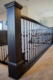 If the staircase currently has wood balusters, remove the wood balusters by cutting them in the middle and removing the top and bottom sections of the baluster. How To Add Wood Handrail To Iron Balustrade Add Wood To Iron Railing