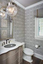 Grey Wallpaper This Grey Powder Room Features A Grey Wallpaper Hardwood Floors And A Metal Powder Room Ideas Elegant Powder Room Vanity Powder Room Wallpaper