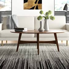 Crafted from manufactured wood and solid rubberwood with oak veneers, its frame features flared legs, an open lower shelf, and a warm pecan brown finish for a natural touch. Modern Coffee Tables Allmodern Coffee Table Furniture Living Room Furniture