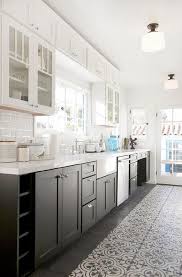 White And Black Kitchen Features Glass Upper Cabinets And Black Lower Cabinets Paired With W White Kitchen Design Gray And White Kitchen Kitchen Cabinet Design