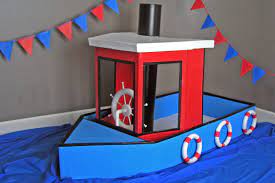 Playhouses Offer Children A Wonderful Outlet For Creativity And Imagination This Cardboard Tugboat Welcomes Kid Cardboard Boat Boat Crafts Cardboard Box Boats