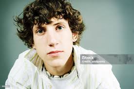 You Man Staring Into The Camera With Serious Face Stock Photo