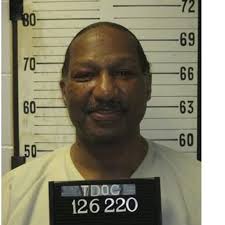 Video surveillance of the suspect from the area of Pipkin Road of the  suspect armed with a black rifle and wearing camouflage pants and a long  sleeve camouflage shirt with a brown