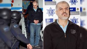 27, 2008 file photo, eduardo arellano felix, also known as the doctor, center, is escorted by masked police officers during his presentation to the press in mexico city. Quiukevcnjnanm