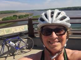 Iowa woman, first female local television sports director in nation, bikes  for climate change.