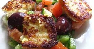 Fried Saganaki With Halloumi On A Greek Tomato Salad With Kalamata Olives