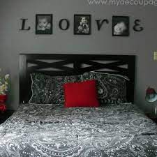 This modern theme master bedroom in black and white color scheme highlights a textured dark gray accent wall and a black leather bed frame with tufted headboard paired with a black leather tufted ottoman. Bedroom Black And Red Bedding Sets Design Black White Grey Red Master Bedroom Gray Wall Color Scheme Red Master Bedroom Bedroom Red Red Bedroom Decor