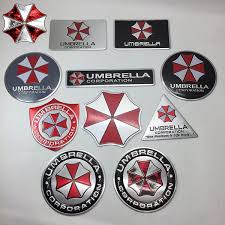 The umbrella corporation was a britishmultinational conglomerate with subsidiaries active in a variety of industries from the 1980s to the early 2000s. 1pc 3d Metal Resident Evil Umbrella Corporation Emblem Badge Car Motorcycle Sticker Decal With Self Adhesive Wish