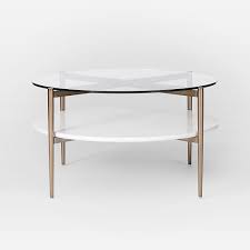 It comes unassembled with its four rounded and polished wooden legs, shaped roughly like boomerangs. Mid Century Art Display Round Coffee Table