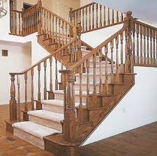 Detailed woodwork on the staircase railing gives added visual interest. Wooden Railing Designs For Duplex Home
