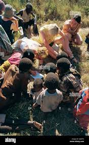 Three 3 young white women meet African children on an overland trip at  Uhenga village bushcamp Tanzania East Africa Stock Photo - Alamy