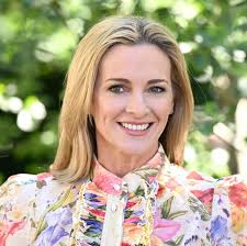 Gabby Logan arrives at Chelsea in a medley of floral ruffles