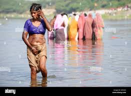 Indian woman bathing in holy hi-res stock photography and images - Alamy